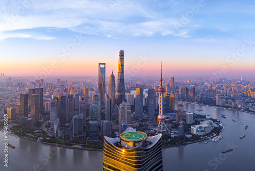 Aerial view of modern city skyline and buildings at sunrise in Shanghai.