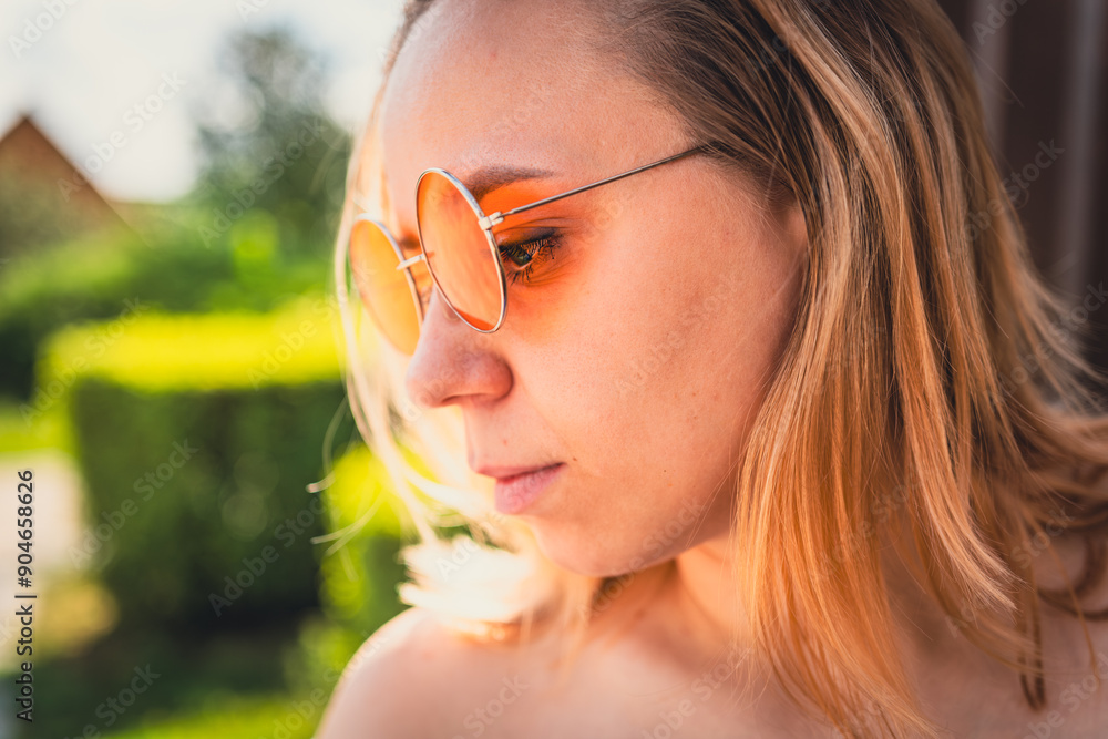 Young Woman With Stylish Sunglasses Enjoying a Sunny Day Outdoors in a Lush Green Garden Young Woman With Stylish Sunglasses Enjoying a Sunny Day Outdoors in a Lush Green Garden