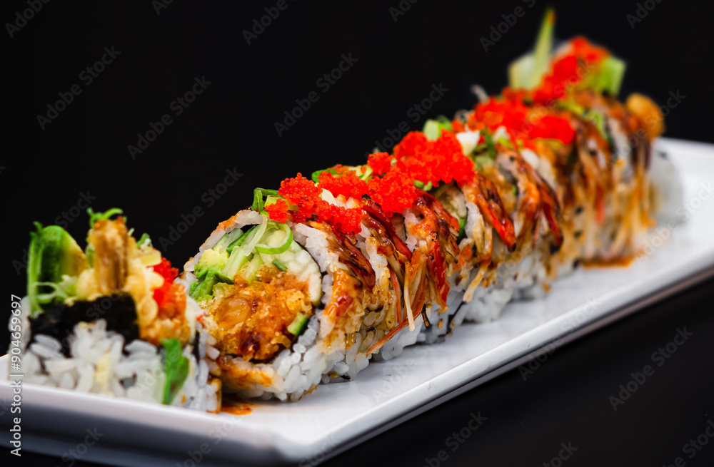 Avocado, Cucumber, Shrimp Tempura, and Spicy Salmon Roll Topped with Torched Spicy Crabmeat, Green Onion, and Fish Eggs Avocado, Cucumber, Shrimp Tempura, and Spicy Salmon Roll Topped with Torched Spicy Crabmeat, Green Onion, and Fish Eggs