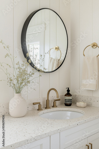 Minimalist bathroom with terrazzo flooring, neutral tones and dark accents