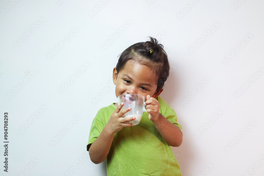 Portrait of asian boy drinking milk and posing on white background Portrait of asian boy drinking milk and posing on white background