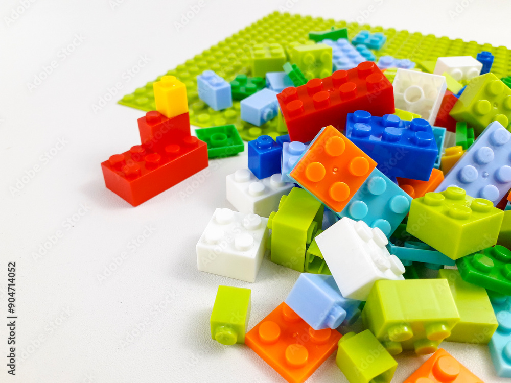 Various colored toy blocks on a white background. Educational toys for children Various colored toy blocks on a white background. Educational toys for children