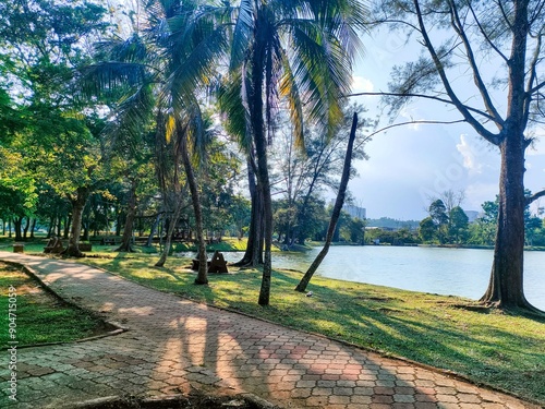 Beutiful landscape with trees, blue sky and wavy lake in the morning at Taman Bandar Kuantan, Pahang, Malaysia photo