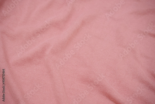 Texture of a pink pastel knitted sweater fabric