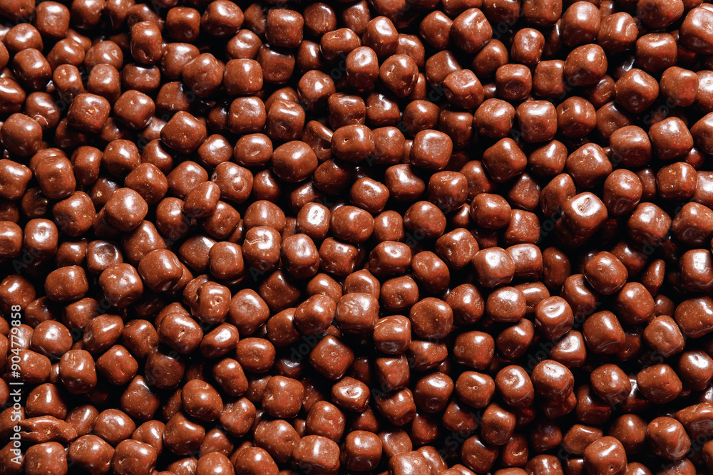 Closeup brown dragee, chocolate covered nuts, sweet candy background Closeup brown dragee, chocolate covered nuts, sweet candy background