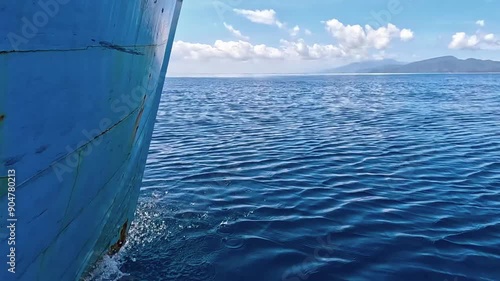 Seascape from moving boat on a sunny day. Beautiful skyscape. Vacation, travel, and holiday concept.