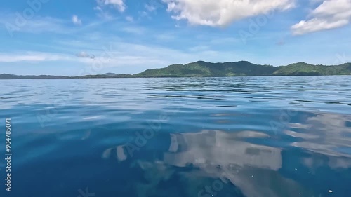 Seascape from moving boat on a sunny day. Vacation, travel, and holiday concept.