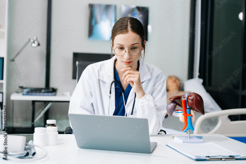 Young female doctor in white medical uniform using laptop and tablet talking video conference call at desk,Doctor sitting at desk and writing a prescription for her patient Young female doctor in white medical uniform using laptop and tablet talking video conference call at desk,Doctor sitting at desk and writing a prescription for her patient