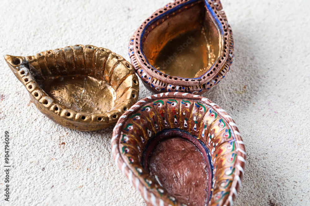 Fototapeta premium Diya lamps for celebration of Divaly on grunge white background