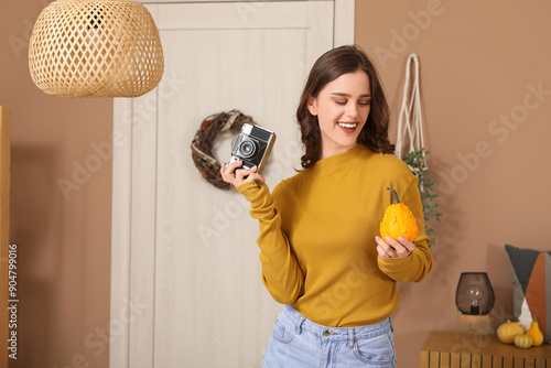 Young woman with pumpkin an...