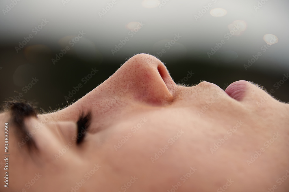 A young woman's face with closed eyes. A young woman's face with closed eyes.