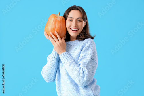 Young woman with pumpkin on...