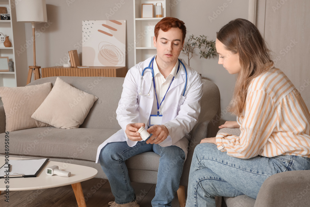 Male doctor prescribing pills to young woman at home Male doctor prescribing pills to young woman at home
