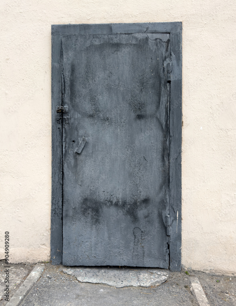 Metal door on the wall of a building Metal door on the wall of a building