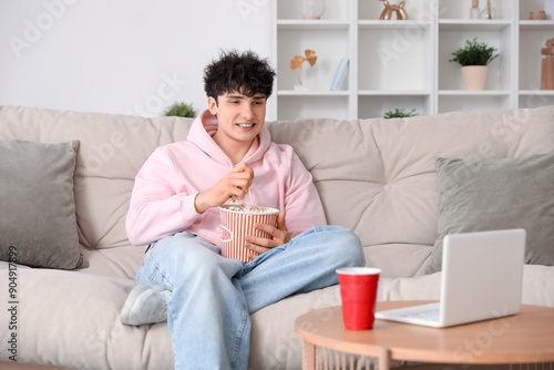 Young man watching movie wi...