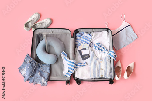 Open suitcase with female c...