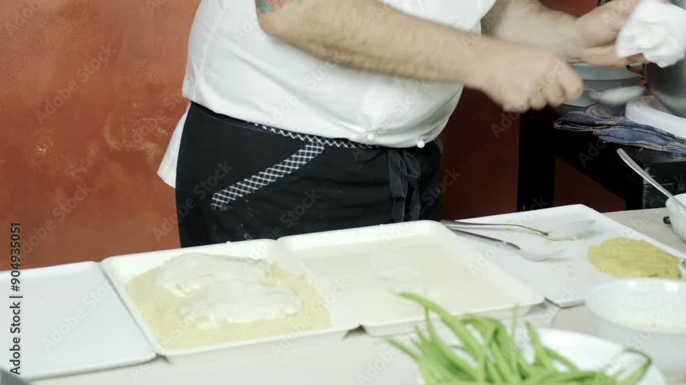 Long shot of italian chef cooking Cotoletta, breaded cutlet, traditional kitchen Long shot of italian chef cooking Cotoletta, breaded cutlet, traditional kitchen