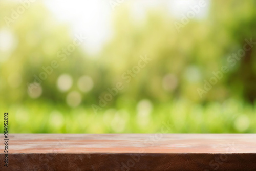 Empty wooden table top with lush green nature bokeh garden background