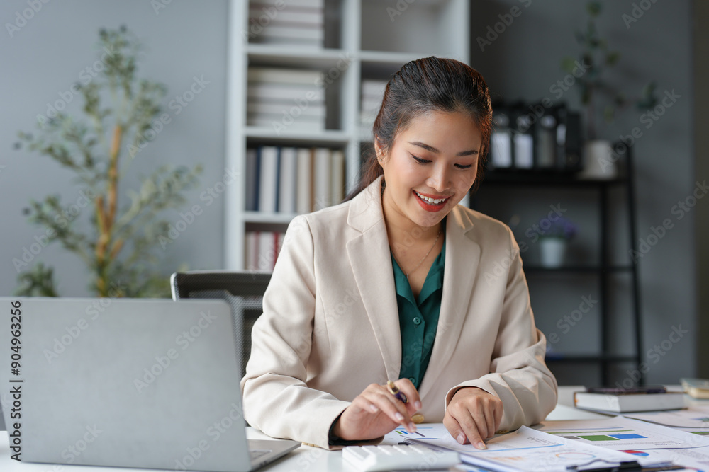 Young Asian businesswoman pointing document data graph and chart paper marketing and investment Statistical profit reports for financial, economic and financial growth. management and planning. Young Asian businesswoman pointing document data graph and chart paper marketing and investment Statistical profit reports for financial, economic and financial growth. management and planning.