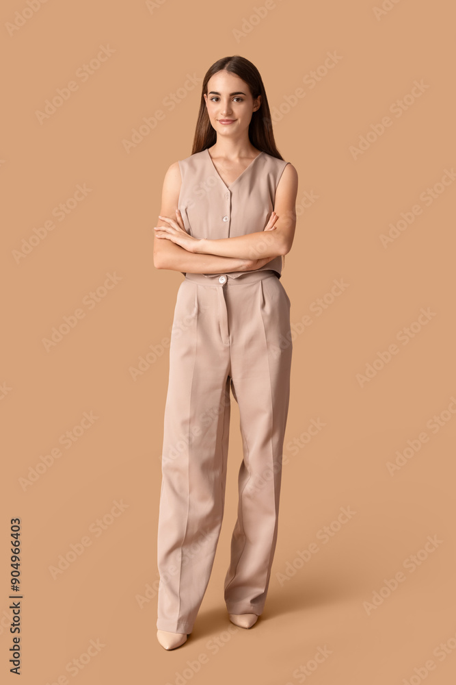 Beautiful young happy woman in stylish outfit on beige background Beautiful young happy woman in stylish outfit on beige background