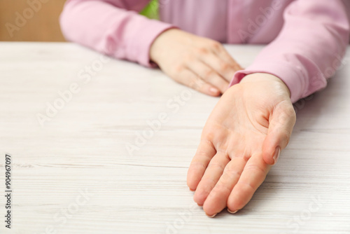 Wallpaper Mural Chiromancy and foretelling. Woman showing palm at white wooden table, closeup. Space for text Torontodigital.ca