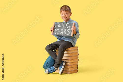Little boy holding chalkboa...