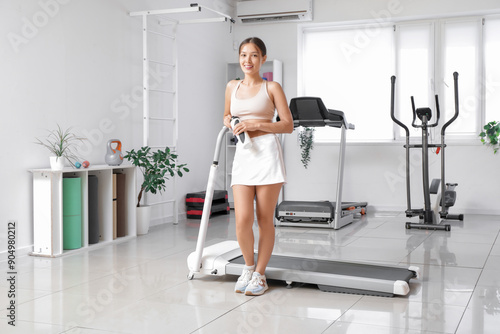 Sporty Asian woman with wat...