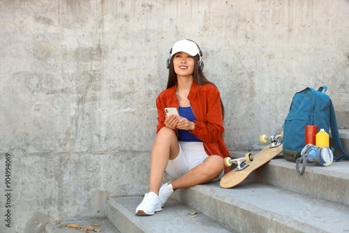 Young Asian woman in headph...