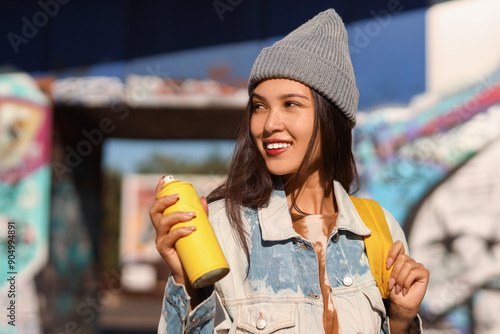 Young Asian woman with spra...