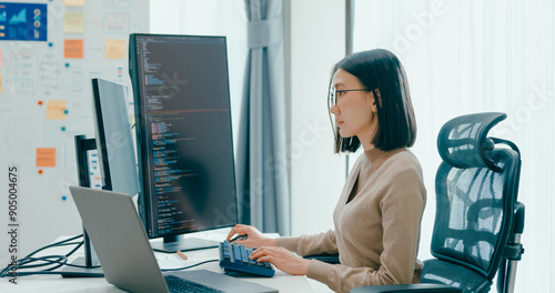 Fotografie Young adult Asia female freelance eyeglasses typing write prompt AI bot IT app smart program nomad, video game, terminal with coding, user interface, designer, big data center on desktop computer