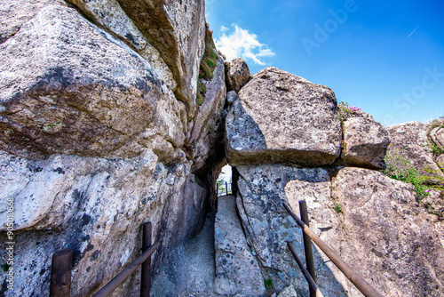 Spring view of hiking trail and steel handrail with rock and hole of Tongcheonmun Gate at Wolchulsan National Park near Yeongam-gun, South Korea
 photo