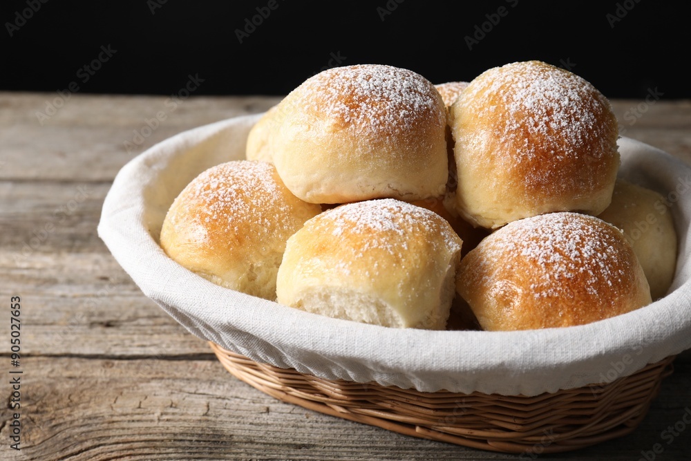 Delicious dough balls in basket on wooden table, closeup Delicious dough balls in basket on wooden table, closeup