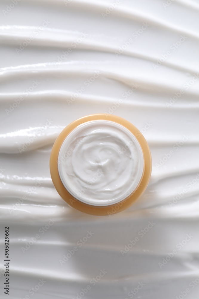 Face cream in jar on cosmetic product, top view Face cream in jar on cosmetic product, top view