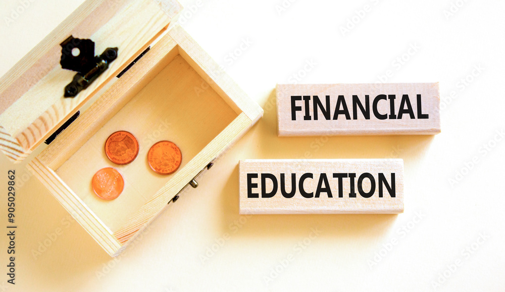 Financial education symbol. Concept words Financial education on beautiful wooden block. Beautiful white paper background. Wooden chest with coins. Business Financial education concept. Copy space. Financial education symbol. Concept words Financial education on beautiful wooden block. Beautiful white paper background. Wooden chest with coins. Business Financial education concept. Copy space.
