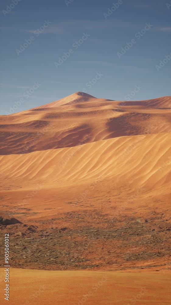 A vast desert landscape featuring dry terrain with a towering mountain in the background under a clear sky. A vast desert landscape featuring dry terrain with a towering mountain in the background under a clear sky.