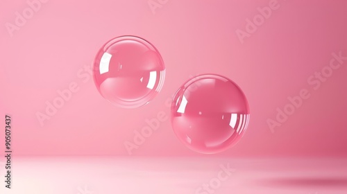 Two transparent spheres floating in mid-air against a vibrant pink background.