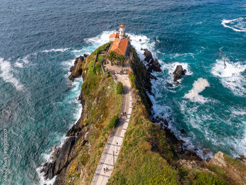 Faro de Cudillero en Asturias con marea muy fuerte photo