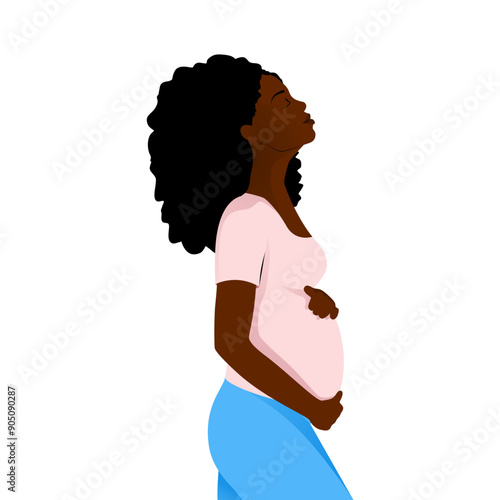 Pregnant african american woman side view in pink shirt and blue jeans tenderly holds her belly with a happy smile