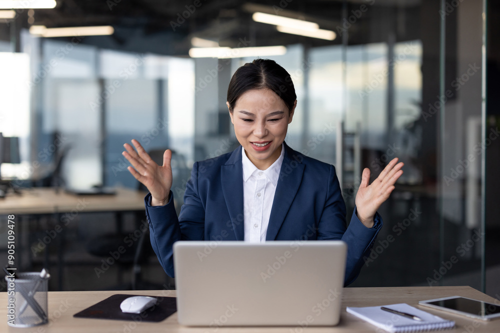 Businesswoman in office looking confused while working on laptop computer. Professional woman trying to solve problem during workday. Office worker in suit dealing with work challenge. Businesswoman in office looking confused while working on laptop computer. Professional woman trying to solve problem during workday. Office worker in suit dealing with work challenge.