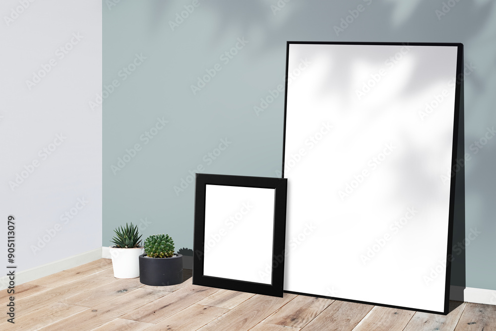 Picture frame mockups leaning against a gray wall on a wooden floor Picture frame mockups leaning against a gray wall on a wooden floor