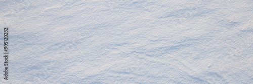Obraz na płótnie Beautiful winter background with snowy ground. Natural snow texture. Wind sculpted patterns on snow surface. Wide panoramic texture for background and design. w salonie
