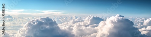 The sky is filled with clouds, creating a sense of vastness and openness. The clouds are scattered throughout the sky, with some appearing closer to the ground and others higher up