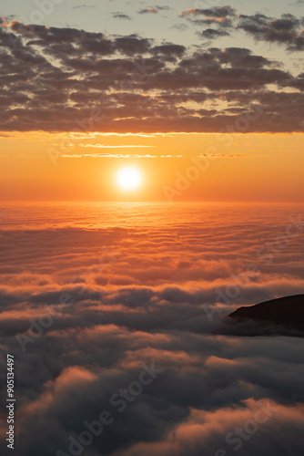 Sea of clouds at dramatic colorful evening sky during the midnight sun in the Lofoten, Northern Norway