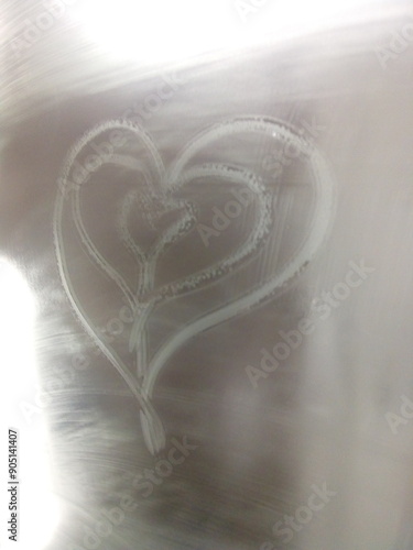 Heart-shaped steam pattern on glass with a soft light background, symbolizing love and romance. Perfect for Valentine s Day, wedding invitations, or any love-themed design project. photo