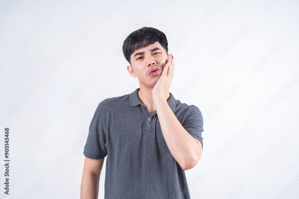 Portrait of handsome Asian man with mouth pain due to tooth decay and gingivitis. Medical and healthcare concept on white background. Portrait of handsome Asian man with mouth pain due to tooth decay and gingivitis. Medical and healthcare concept on white background.