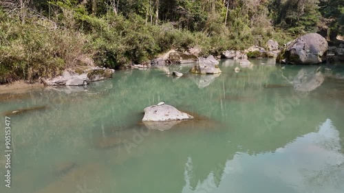 日本の風景 緑色の渓流と、苔のむした立派な岩をドローンで空撮 宮崎県の観光地