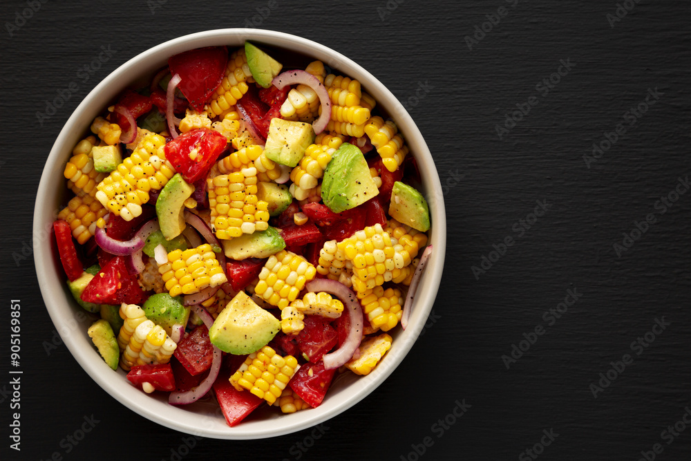 Healthy Fresh Corn Salad in a Bowl on a black background, top view. Flat lay, overhead, from above. Copy space. Healthy Fresh Corn Salad in a Bowl on a black background, top view. Flat lay, overhead, from above. Copy space.