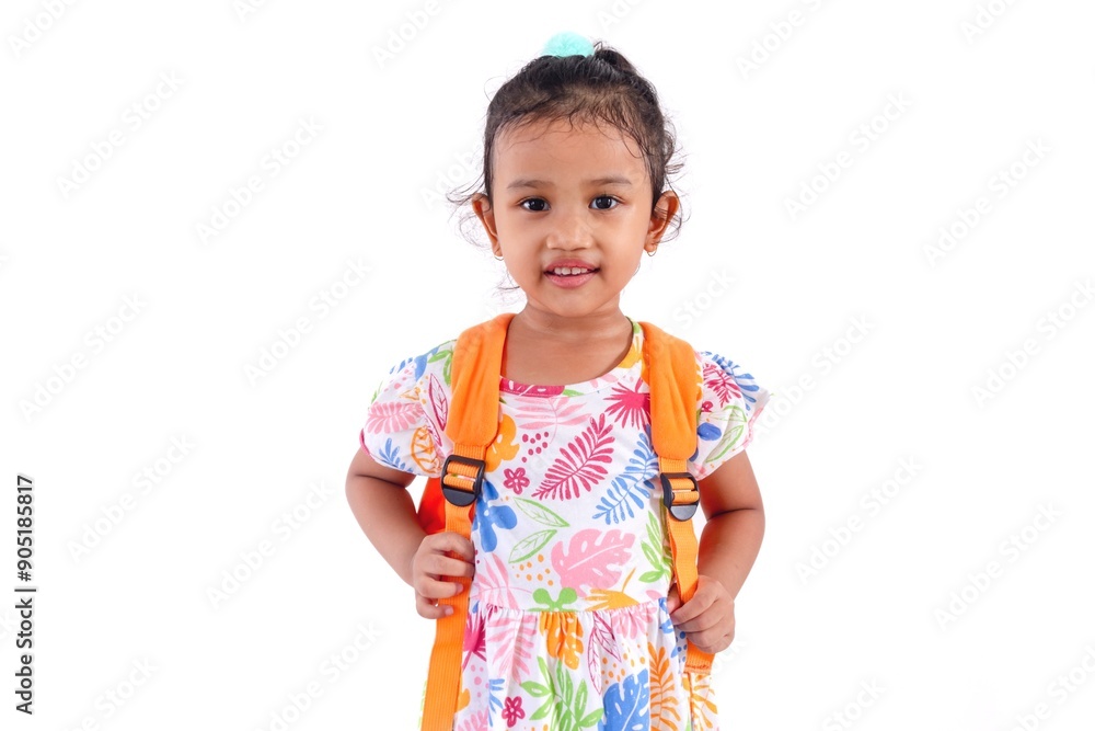A happy little Asian girl in a colorful dress posing with her school bag. Tired after school. A happy little Asian girl in a colorful dress posing with her school bag. Tired after school.