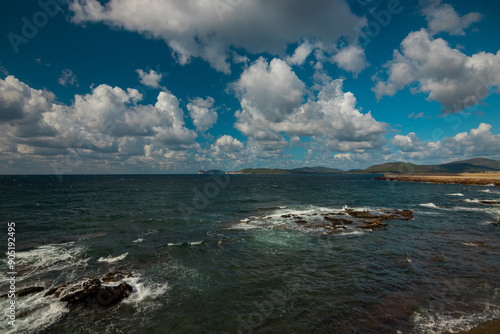 Rocky vulcanic beaches and high mountains of Sardinia island, Italy