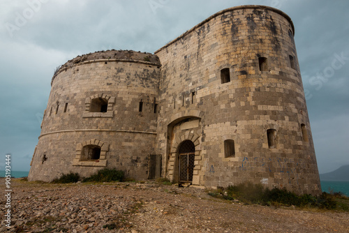 Montenegrin beach with a fortress in cloudy weather photo